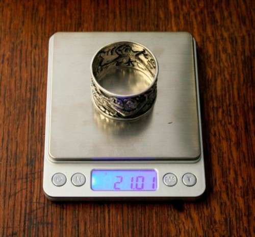 An incredible and rare Chinese solid silver "Dragon" napkin ring with amazing hand chased detailing