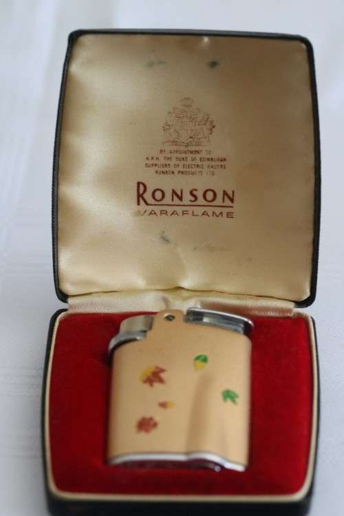 A lovely Ronson Varaflame "Starfire" lighter with a custom "leaf" design in the original box