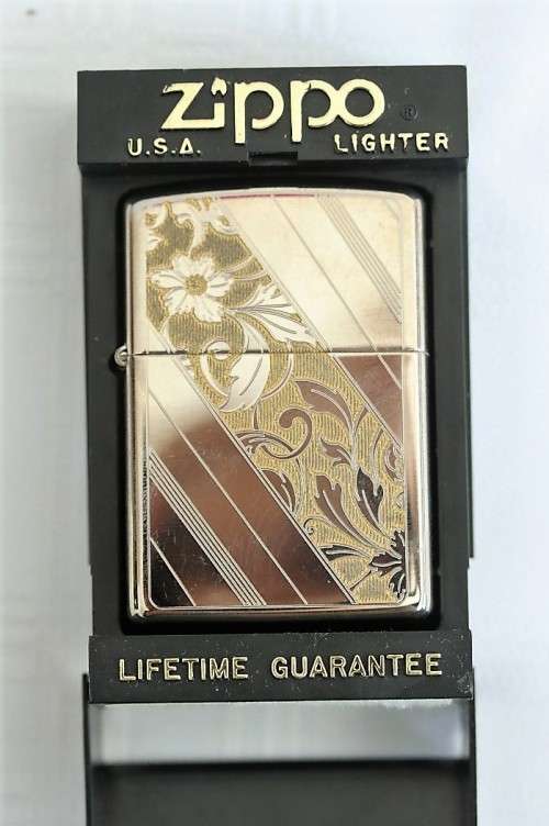 An original silver plated Zippo "limited edition" floral etched design lighter in its box