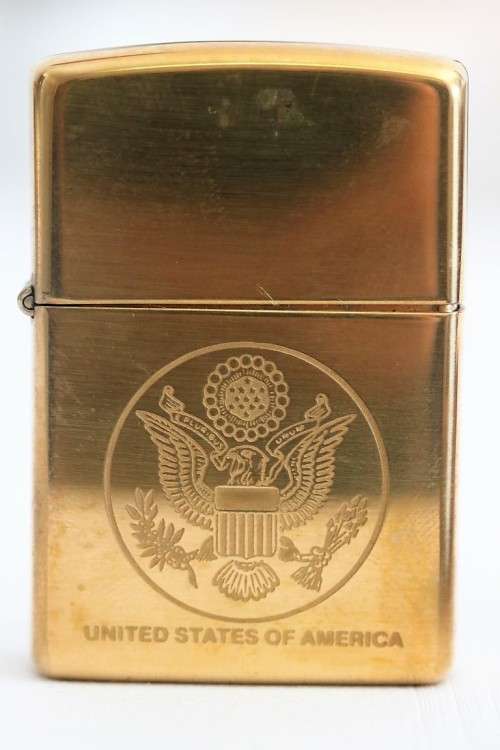 A wonderful original Gold tone Zippo "United States of America" lighter in the original box
