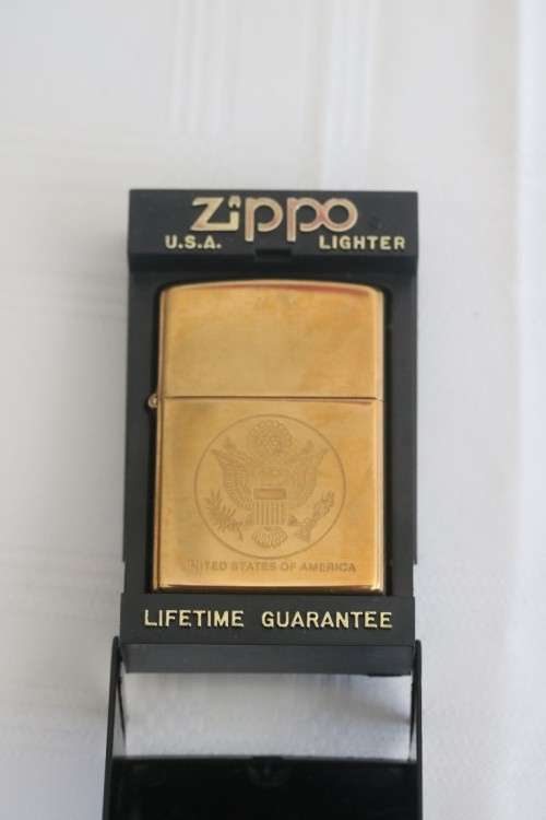 A wonderful original Gold tone Zippo "United States of America" lighter in the original box