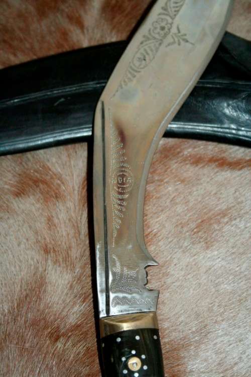 An incredible hand made authentic Nepalese "Kukri" (Gurkha) knife in its original leather sheath