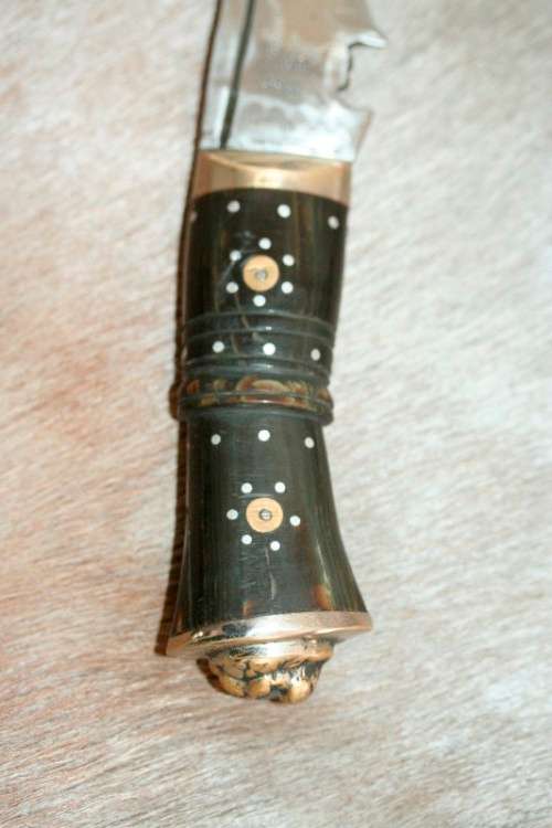 An incredible hand made authentic Nepalese "Kukri" (Gurkha) knife in its original leather sheath