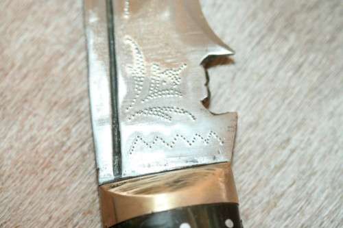 An incredible hand made authentic Nepalese "Kukri" (Gurkha) knife in its original leather sheath