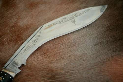 An incredible hand made authentic Nepalese "Kukri" (Gurkha) knife in its original leather sheath