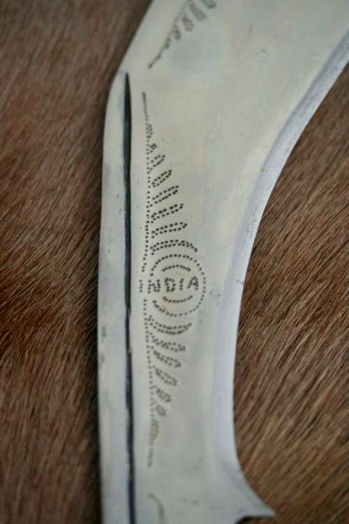 An incredible hand made authentic Nepalese "Kukri" (Gurkha) knife in its original leather sheath