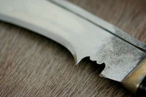 An incredible hand made authentic Nepalese "Kukri" (Gurkha) knife in its original leather sheath