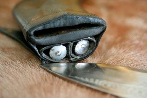 An incredible hand made authentic Nepalese "Kukri" (Gurkha) knife in its original leather sheath