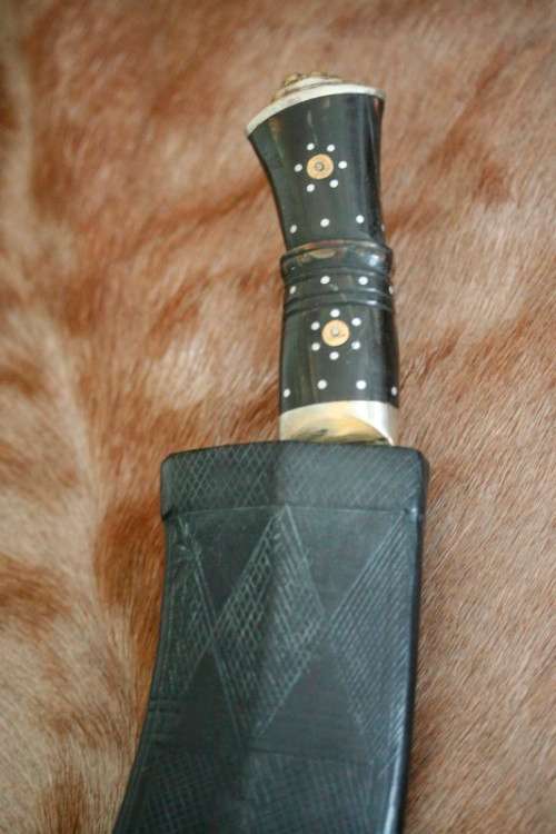 An incredible hand made authentic Nepalese "Kukri" (Gurkha) knife in its original leather sheath