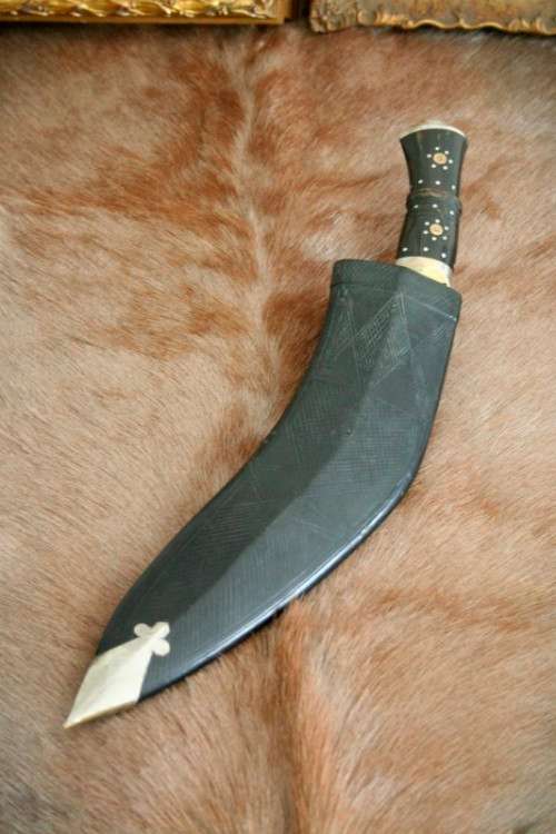An incredible hand made authentic Nepalese "Kukri" (Gurkha) knife in its original leather sheath