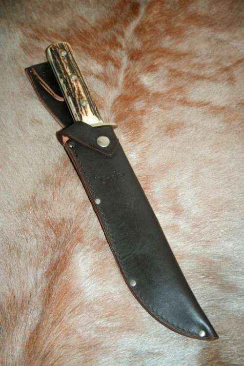 A superb original handmade German Solingen Inox Linder Bowie knife in its embossed leather scabbard