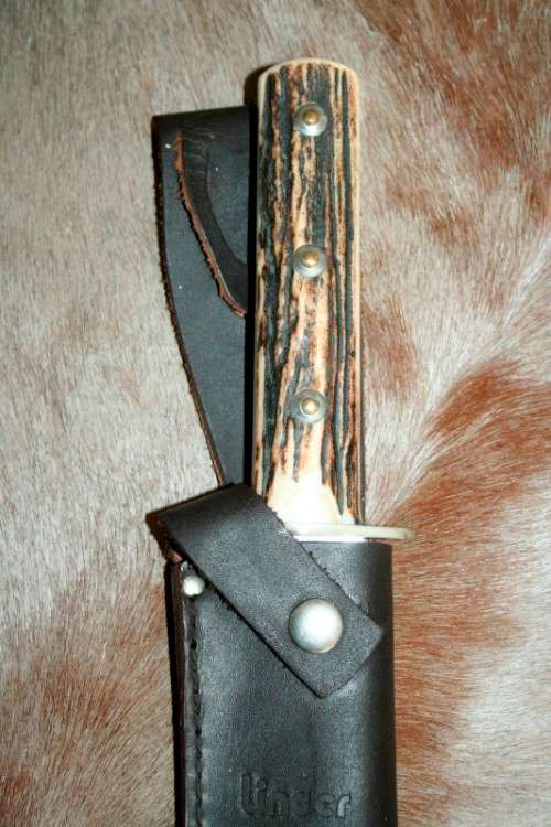 A superb original handmade German Solingen Inox Linder Bowie knife in its embossed leather scabbard