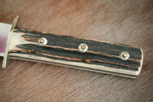 A superb original handmade German Solingen Inox Linder Bowie knife in its embossed leather scabbard