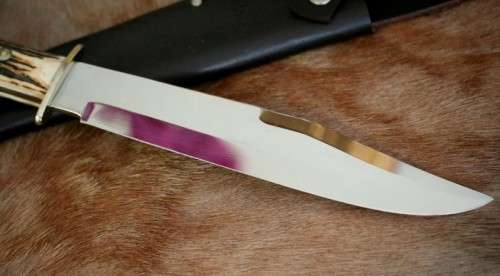 A superb original handmade German Solingen Inox Linder Bowie knife in its embossed leather scabbard