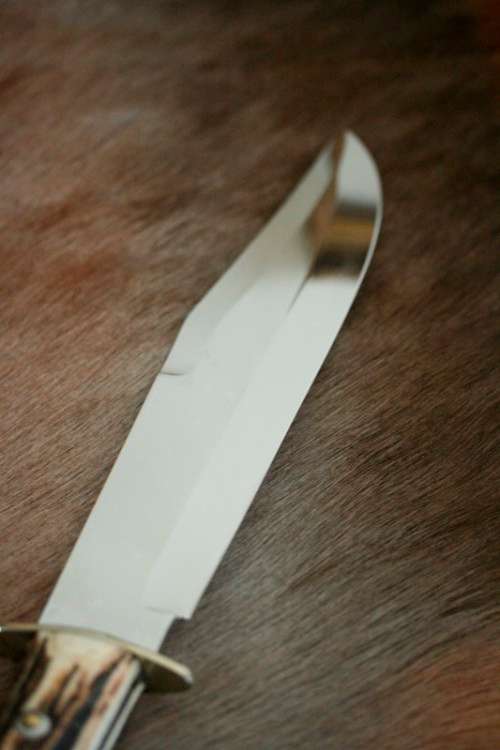 A superb original handmade German Solingen Inox Linder Bowie knife in its embossed leather scabbard