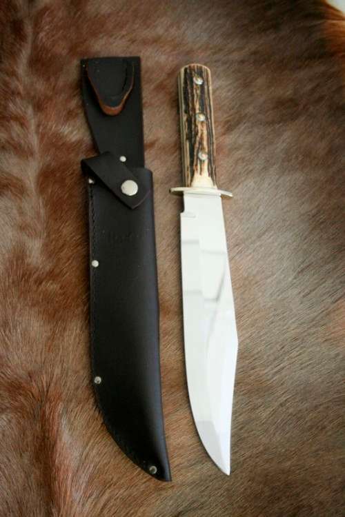 A superb original handmade German Solingen Inox Linder Bowie knife in its embossed leather scabbard