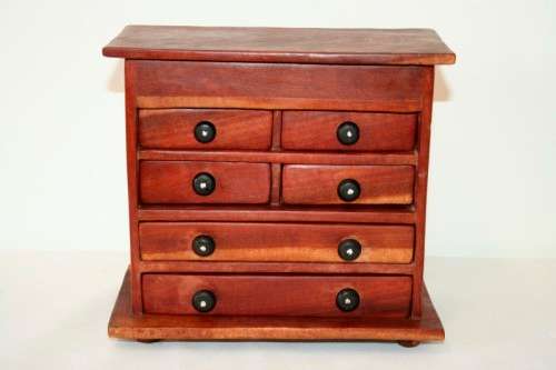 An awesome hand made solid teak jewellery box with six drawers and a storage tray under the lid