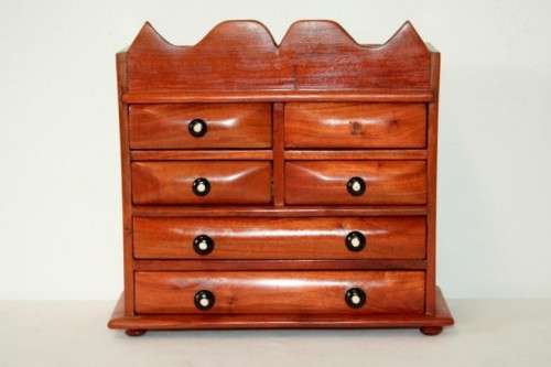 A gorgeous hand made solid teak jewellery box with six drawers and a storage section on top