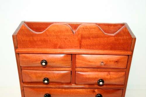 A gorgeous hand made solid teak jewellery box with six drawers and a storage section on top