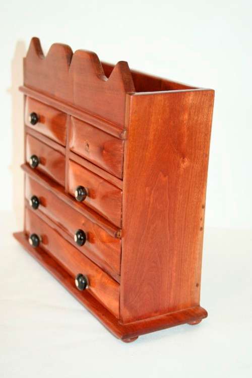 A gorgeous hand made solid teak jewellery box with six drawers and a storage section on top