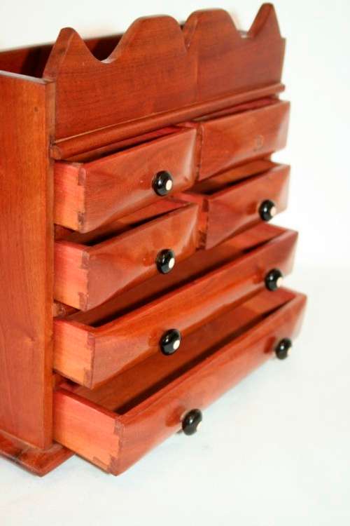 A gorgeous hand made solid teak jewellery box with six drawers and a storage section on top