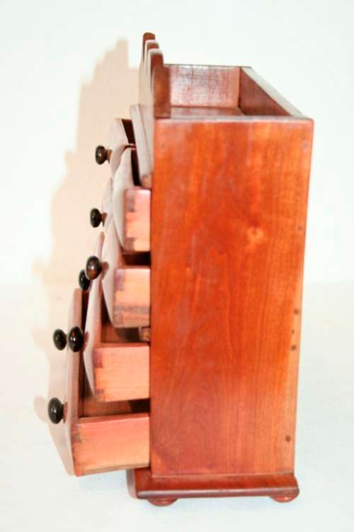 A gorgeous hand made solid teak jewellery box with six drawers and a storage section on top