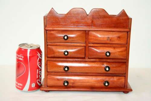 A gorgeous hand made solid teak jewellery box with six drawers and a storage section on top