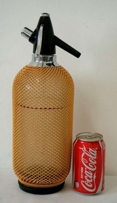 An incredible gold-mesh soda syphon spritzer in its original box in superb condition - never used