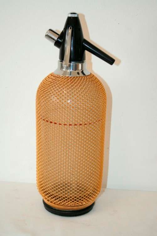 An incredible gold-mesh soda syphon spritzer in its original box in superb condition - never used