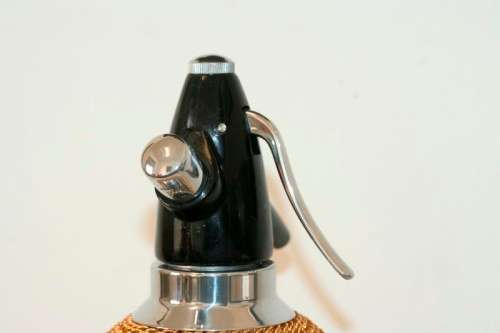 An incredible gold-mesh soda syphon spritzer in its original box in superb condition - never used