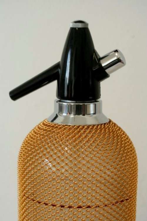An incredible gold-mesh soda syphon spritzer in its original box in superb condition - never used