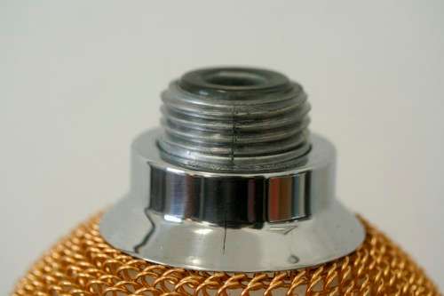 An incredible gold-mesh soda syphon spritzer in its original box in superb condition - never used