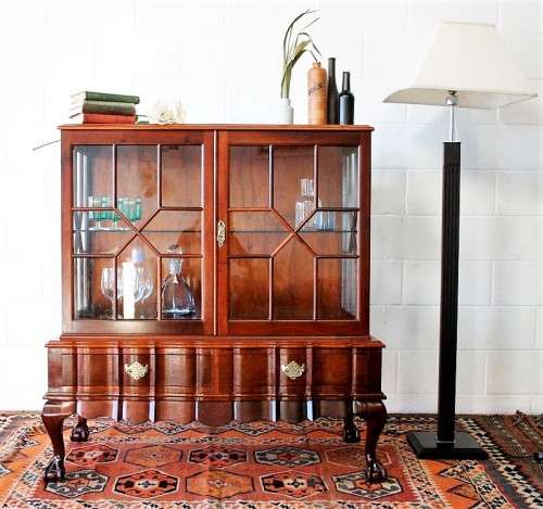 A beautiful vintage Imbuia ball and claw double door show-cabinet with two drawers & glass shelf.