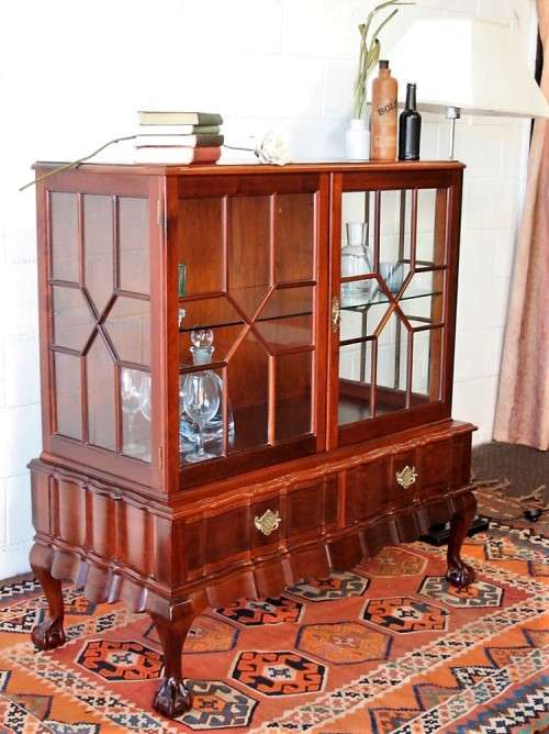 A beautiful vintage Imbuia ball and claw double door show-cabinet with two drawers & glass shelf.