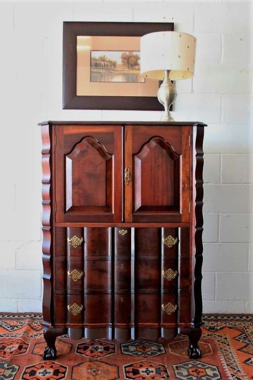 A beautiful vintage ball and claw "Tallboy" multi-purpose cabinet with 3 drawers and scalloped edges