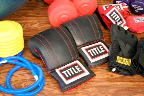 An incredible collection of gym exercise equipment including gloves, a skipping rope, weighs & more