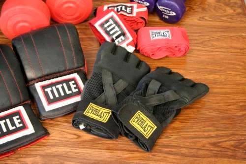 An incredible collection of gym exercise equipment including gloves, a skipping rope, weighs & more