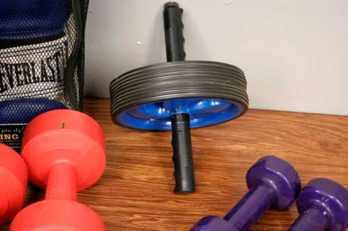 An incredible collection of gym exercise equipment including gloves, a skipping rope, weighs & more
