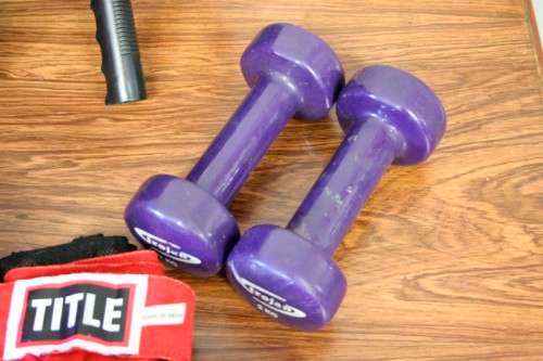 An incredible collection of gym exercise equipment including gloves, a skipping rope, weighs & more