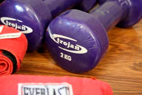 An incredible collection of gym exercise equipment including gloves, a skipping rope, weighs & more