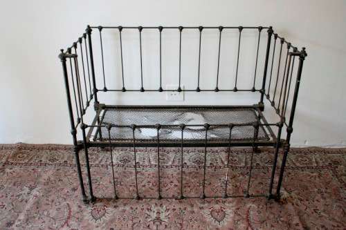 A stunning & rare antique (late 1800's) wrought iron baby's cot w/ dropside on its original castors