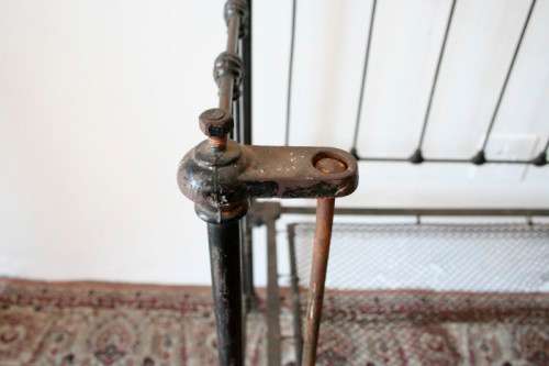 A stunning & rare antique (late 1800's) wrought iron baby's cot w/ dropside on its original castors