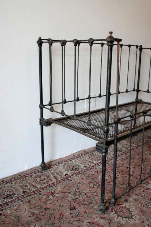 A stunning & rare antique (late 1800's) wrought iron baby's cot w/ dropside on its original castors