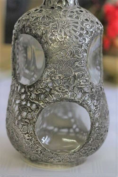 An incredible antique 3-sided 900 solid silver overlay decanter and stopper with a dragon motif