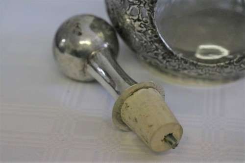 An incredible antique 3-sided 900 solid silver overlay decanter and stopper with a dragon motif