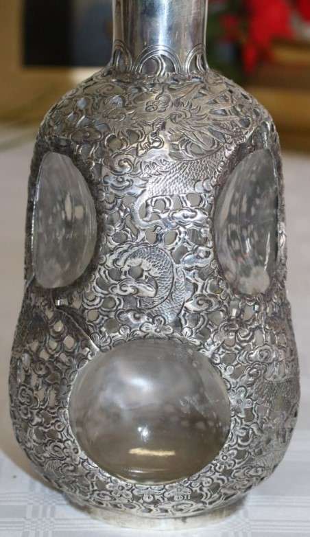 An incredible antique 3-sided 900 solid silver overlay decanter and stopper with a dragon motif