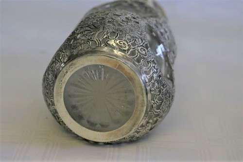 An incredible antique 3-sided 900 solid silver overlay decanter and stopper with a dragon motif