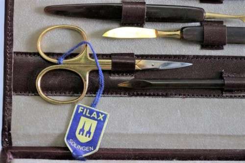 An incredible German made Filax gold plated "Solingen" manicure set in a genuine leather case