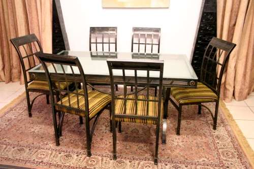Make an offer! Quality 6-seater wrought iron patio table w 6 upholstered chairs. Summer is here!!!