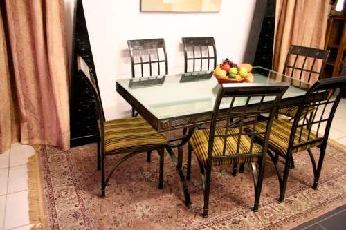 Make an offer! Quality 6-seater wrought iron patio table w 6 upholstered chairs. Summer is here!!!